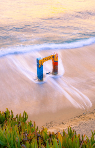 A picture of a a blue and red gate in the sea